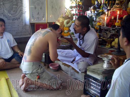 Ajarn Terng lays the Ruesi mask on the devotees head