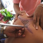 Ajarn Bunmee tattooing sak yant - apart from tattooing in kalasin in the Isan country he also travels around visiting Looksit around Thailand and tattoing them in their homes