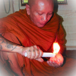 Luang Por Chanai performs Kasina Magic using a candle.