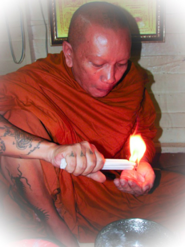 Luang Por Chanai performs Kasina Magic using a candle.